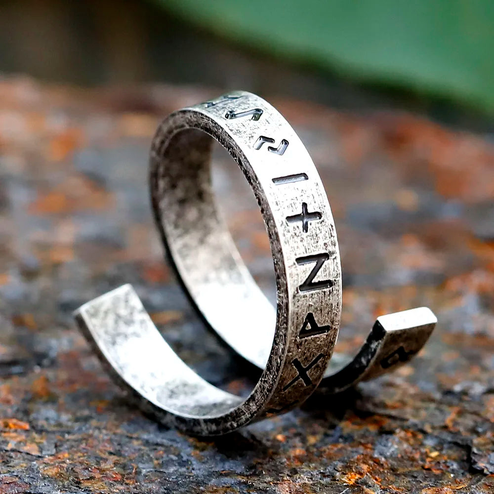 Norse-inspired Viking ring in stainless steel on plain background