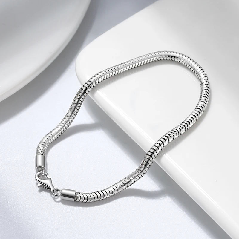 Sleek 925 sterling silver snake chain bracelet with lobster clasp, rhodium plated for a smooth finish and long-lasting shine.