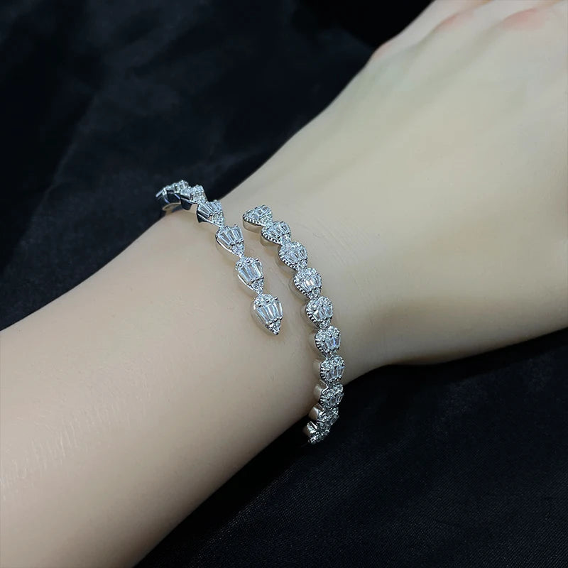 Close-up of silver zircon bangle bracelet worn on model’s wrist for size reference