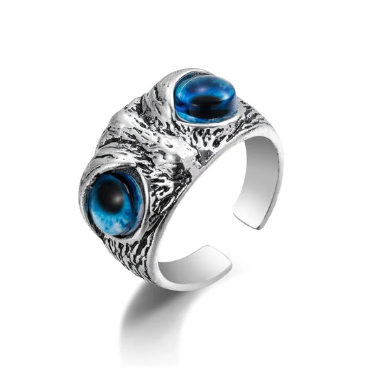 Silver-tone alloy ring with twin blue zircon gemstones in vintage claw setting.