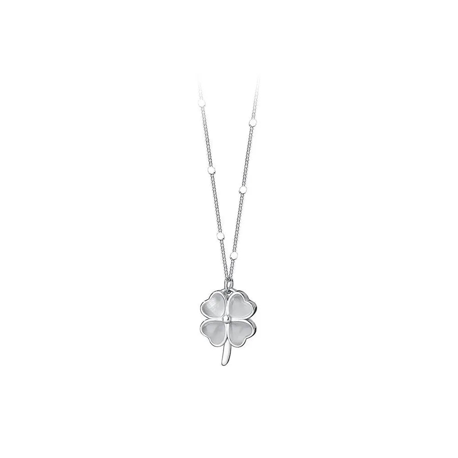 Close-up of silver clover pendant with cat’s eye stone on white background