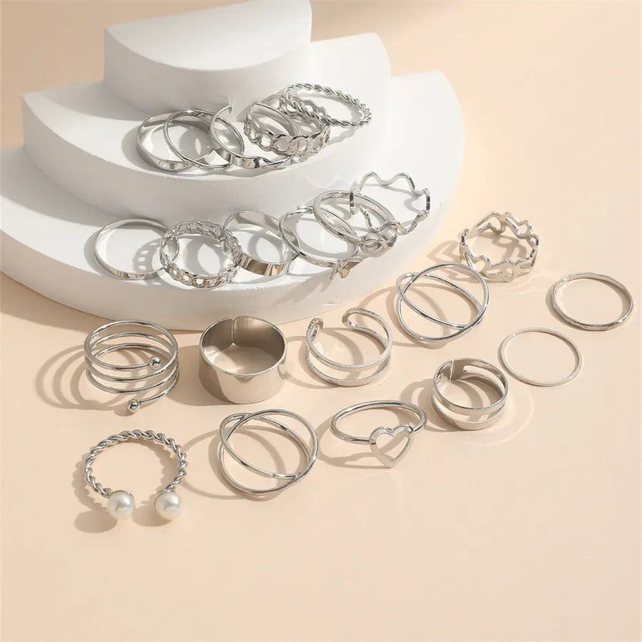 Collection of silver women’s rings with retro styling and pearl accents