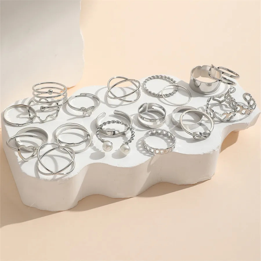 Display stand with silver retro-style women’s rings and pearl details