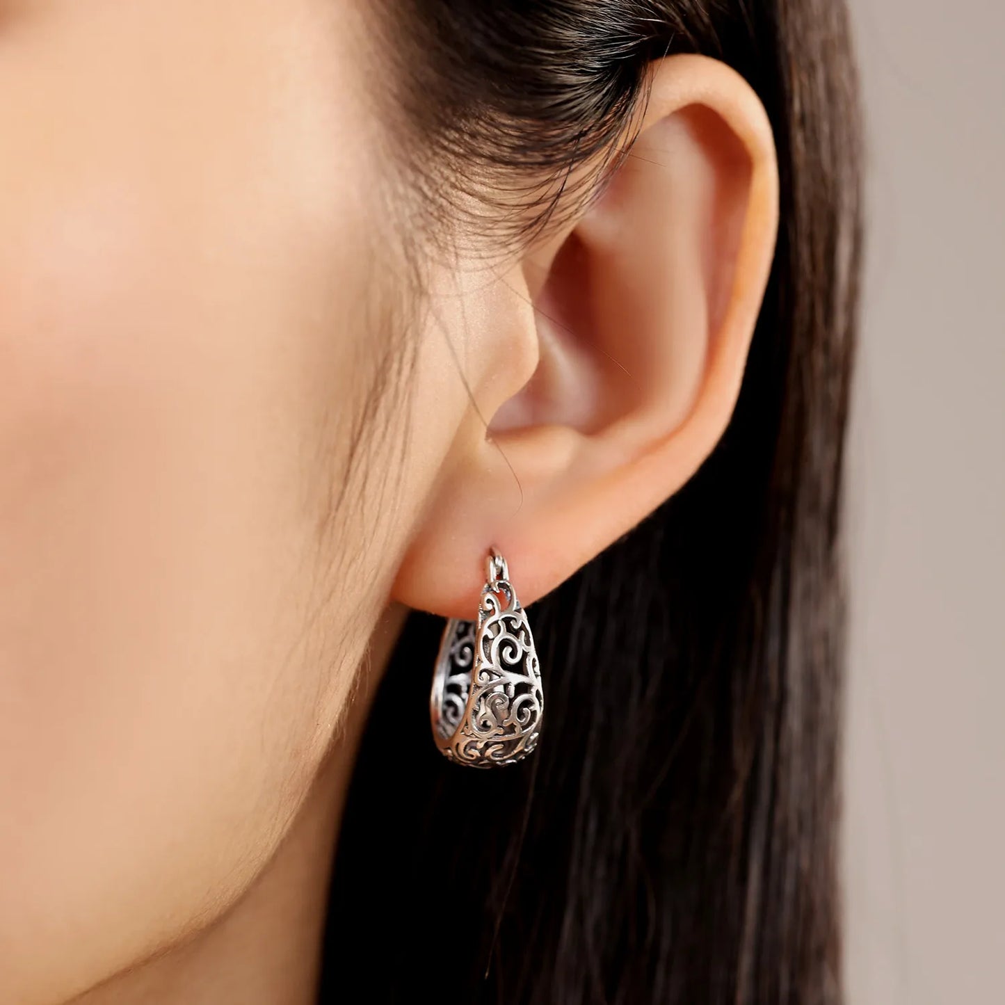 Vintage vine hoop earrings worn by a model, showcasing elegant fit and shine