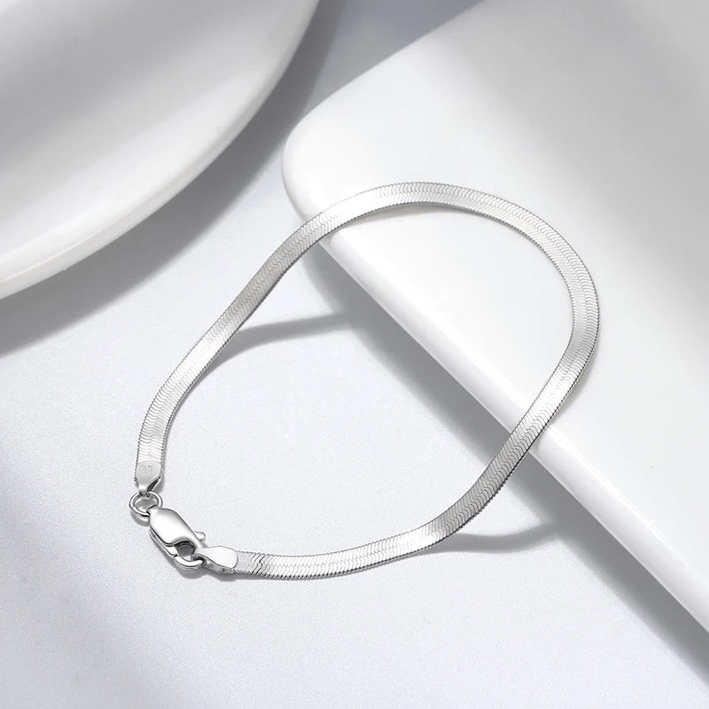 Elegant 925 sterling silver herringbone bracelet with a smooth flat design and lobster clasp, rhodium plated for a sleek finish and durability