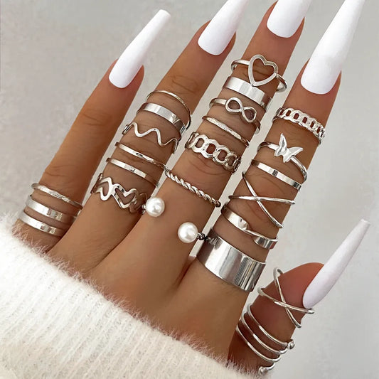 Woman wearing multiple silver retro-style rings with pearl accents